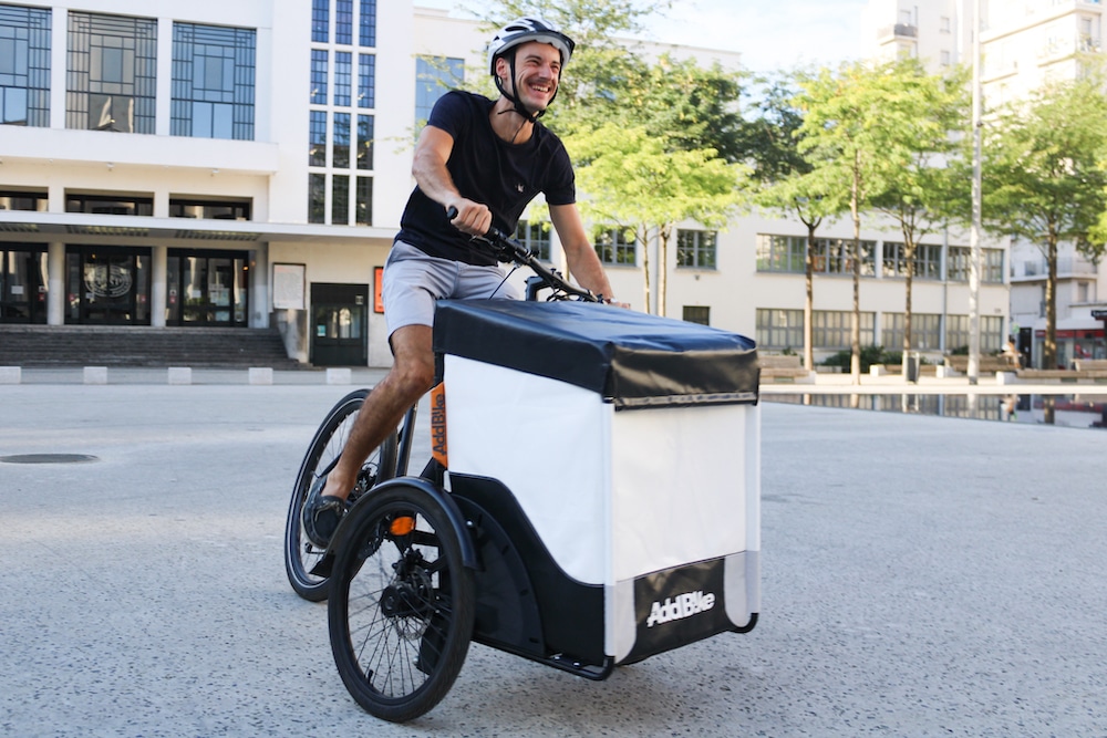 Load bike delivery by smiling person on the Box Kit