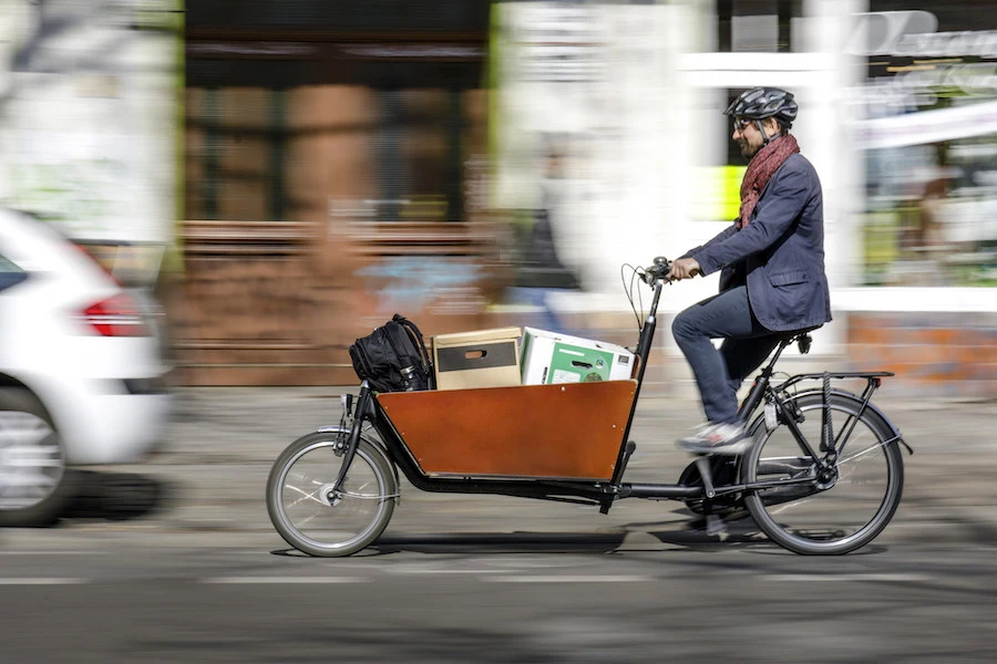 UK cargo bikes parcel delivery on a box bike in wood