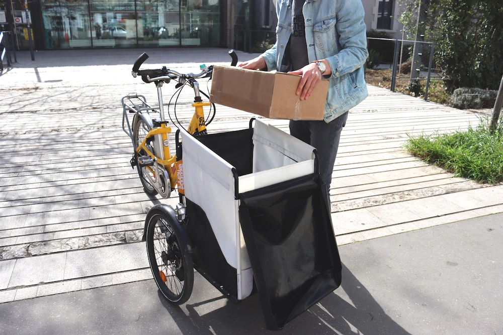 UK cargo bikes: deliveryman removing a large parcel from a trike